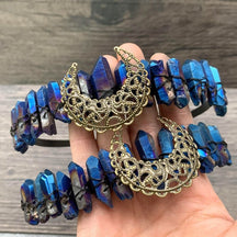 Blue iridescent crystal crowns with gold-tone filigree crescents held together.
