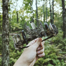 Smoky quartz moon tiara held outdoors, showing its open crescent and irregular points.
