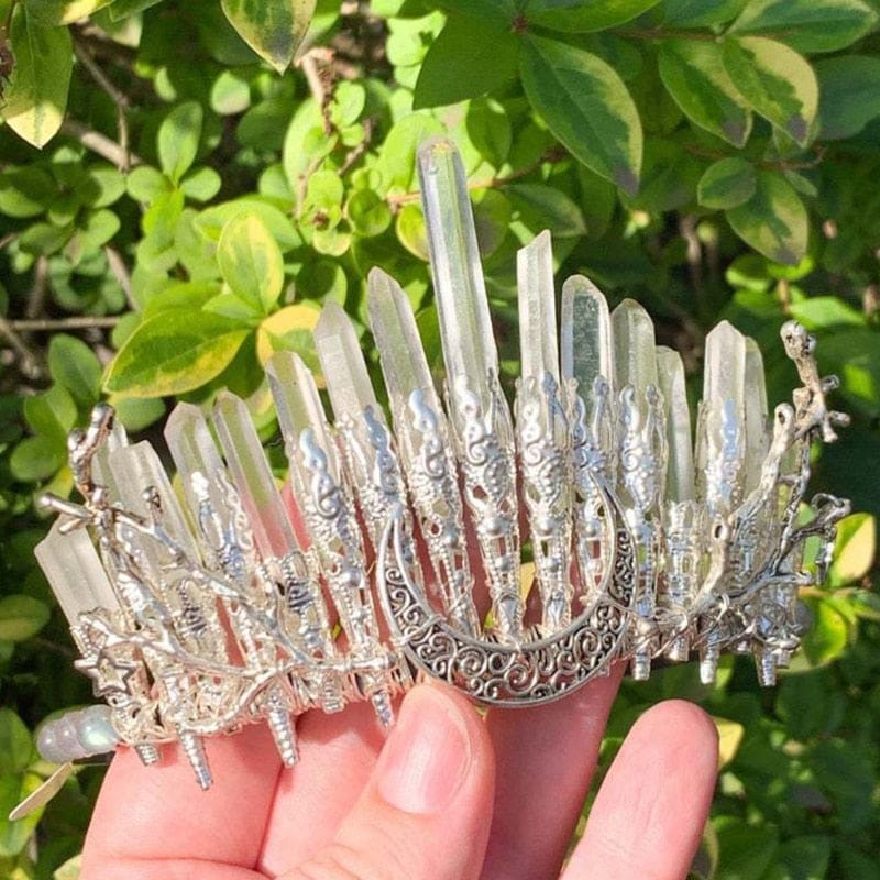 Clear quartz moon crown held outdoors, showing the different heights of its natural points.