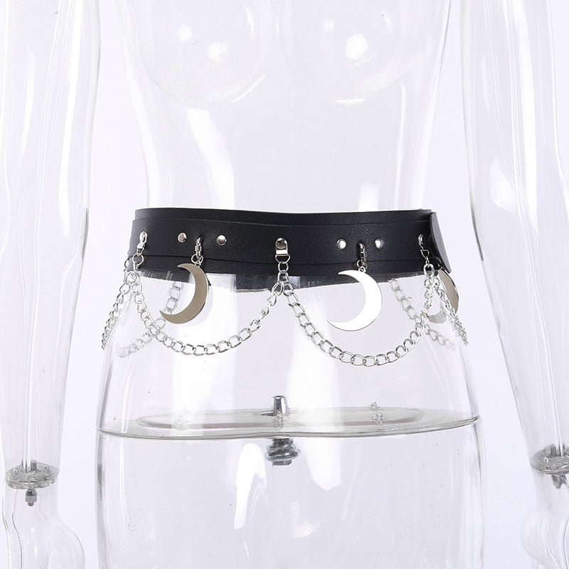 Back view of the black crescent moon belt on a clear mannequin, with hanging silver-tone moons and chains spread across the waist.