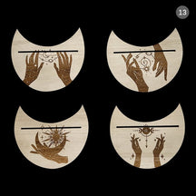 Four moon-shaped wooden card holders decorated with different mystic hand and eye motifs, each with a narrow card slot.