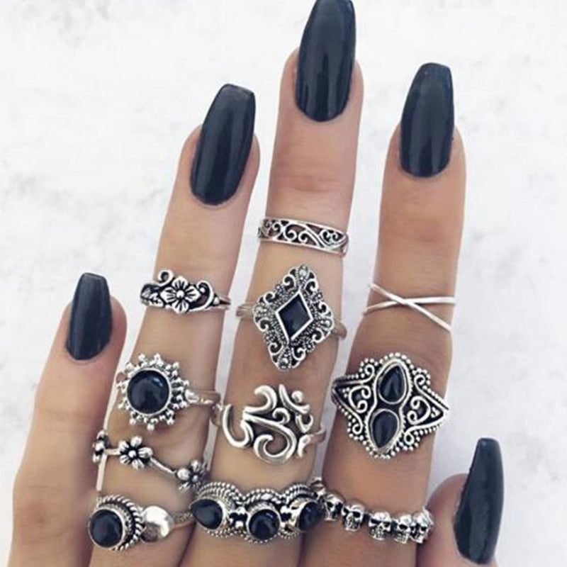 Eleven-piece silver-tone Namaste ring set with black accents shown in another worn arrangement with dark nail polish.