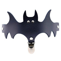 Navy blue bat garter showing its wide wing silhouette and central stocking attachment.