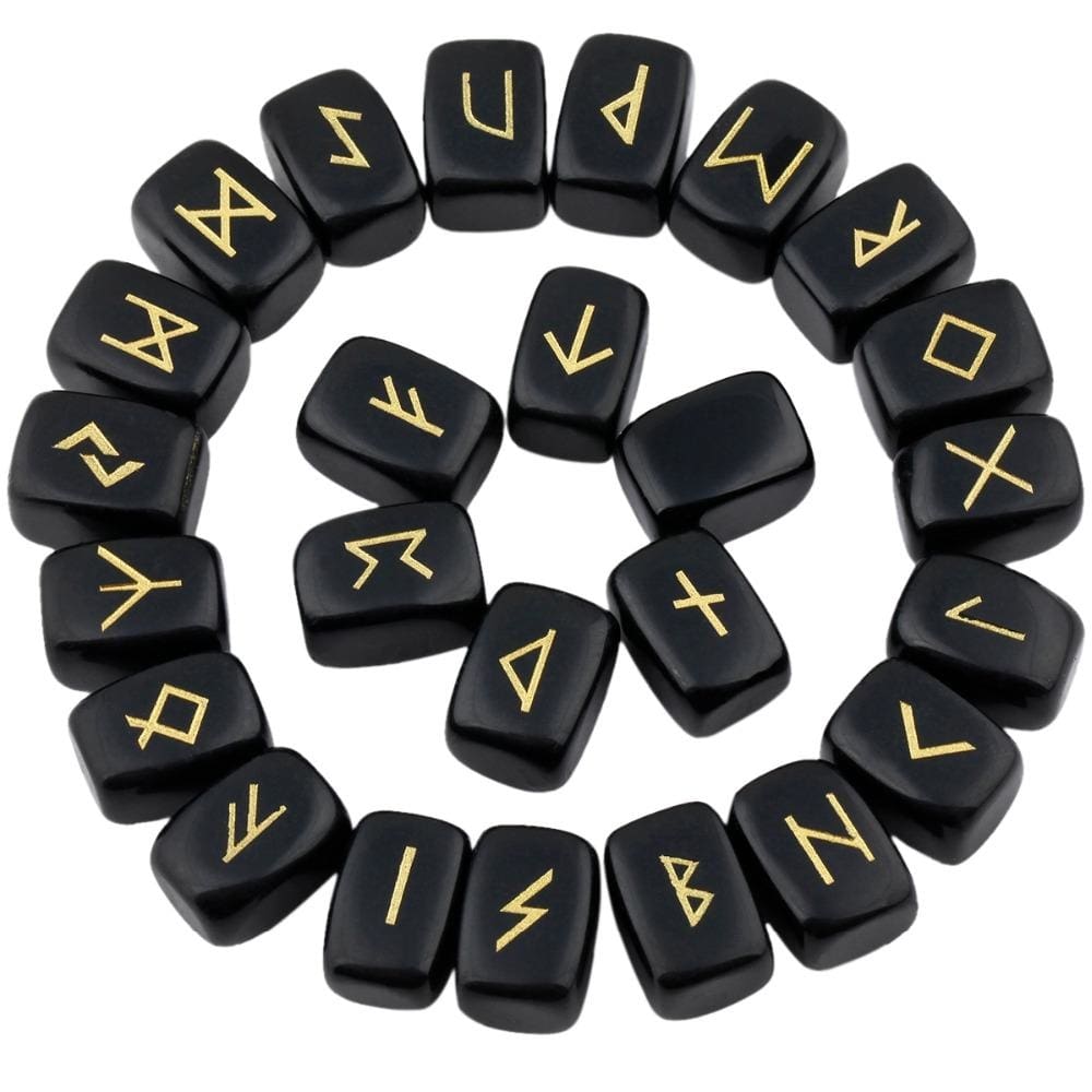 Obsidian rune stones arranged in a circle, with glossy black polished surfaces and gold-coloured characters. The set includes a blank stone.