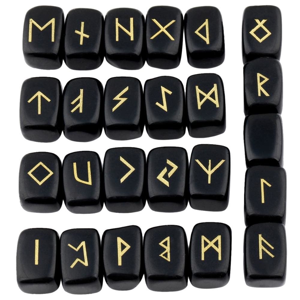 Obsidian rune stone set laid out in rows, showing individual gold-coloured characters and one unmarked stone against glossy black surfaces.