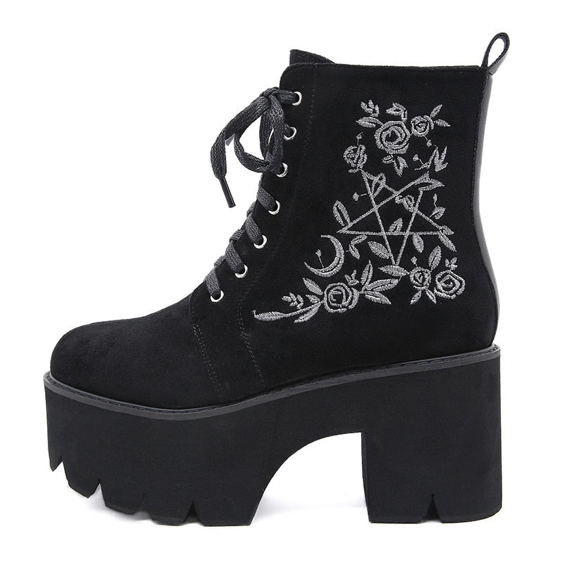 Black platform ankle boots with white pentagram, moon and rose embroidery with a close view of the embroidered side panel.