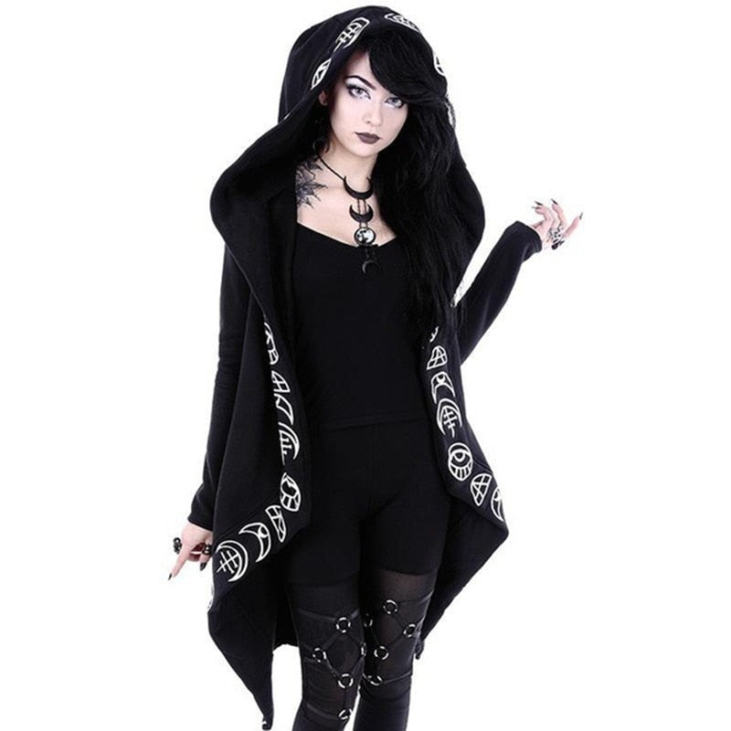 Black open-front hooded cardigan with white occult-style symbols tracing the hood and draped front edges. It is worn over separate black clothing, with the long pointed hem falling beside the legs.