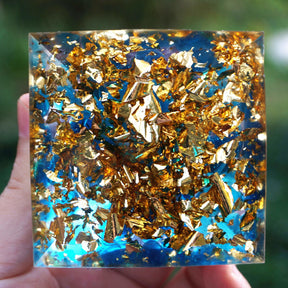 Underside of the Om pyramid, showing blue quartz pieces and gold-tone flecks across the square base.