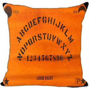 Orange square pillow cover with curved black alphabet rows, numbers, Yes and No labels, small corner motifs and Good Night lettering.