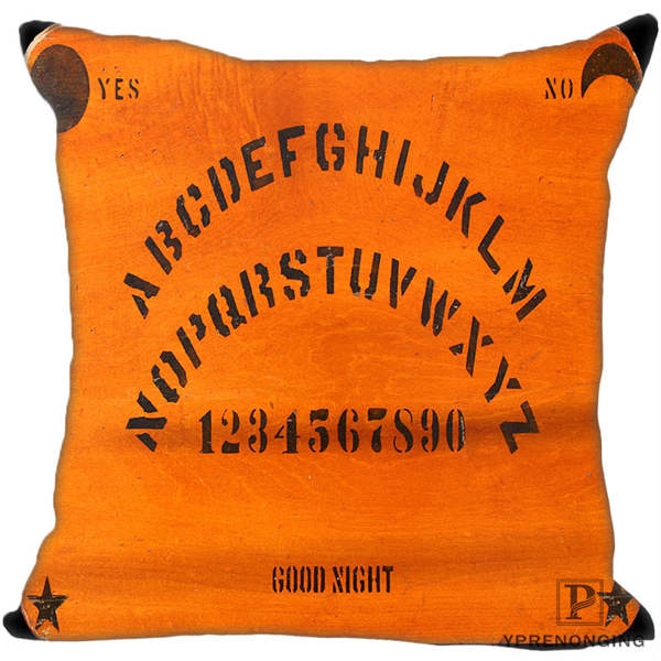 Orange square pillow cover with curved black alphabet rows, numbers, Yes and No labels, small corner motifs and Good Night lettering.