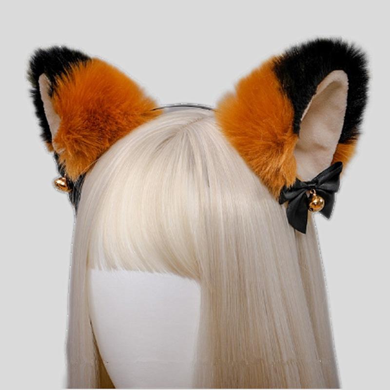 Fuzzy orange and black cat ear headband with pale inner ears, black ribbon bows, and gold-tone bells