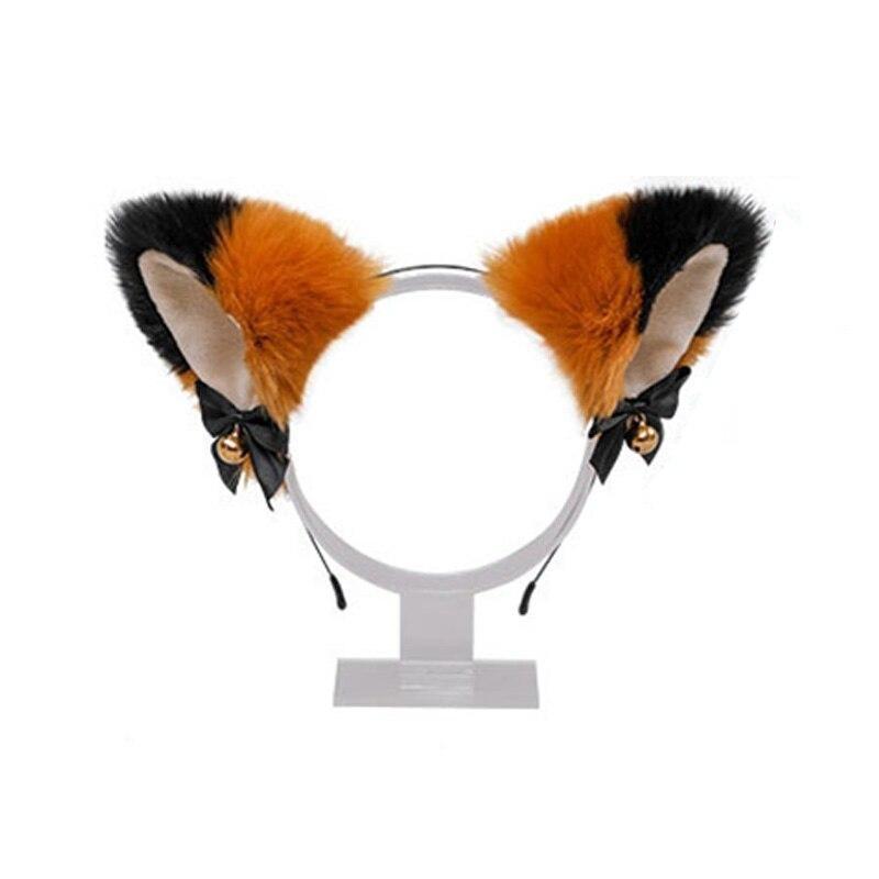 Fuzzy orange and black cat ear headband with pale inner ears, black ribbon bows, and gold-tone bells
