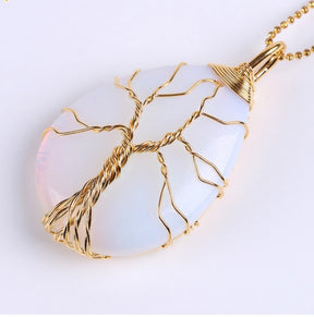 Pale Opal option pendant on a gold-tone chain, with branching gold-tone wirework over the light-coloured stone.