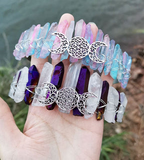 Pastel rainbow and purple-clear triple moon crowns held together, comparing their pale points and silver-tone lunar centres.