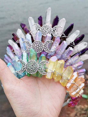 Light-coloured triple moon crystal crowns grouped together, including purple-clear, pastel and soft rainbow point arrangements.