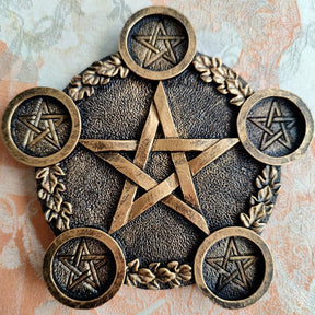 Bronze-tone pentagram holder with raised leaf details and five smaller stars on the round candle platforms.