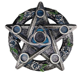 Silver-tone pentacle holder with a central triquetra and a ring of dark roses, green leaves and five blue-toned circular candle spaces.