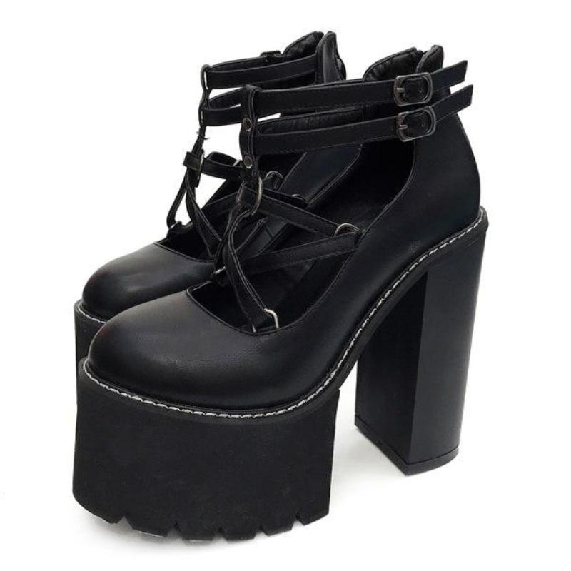 Black pentagram platform heels displayed as a pair, with crossing star straps, double ankle buckles and tall block heels.