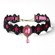 Black lace choker with an ornate oval centerpiece and hanging teardrop in the Pink ribbon and jewel option.
