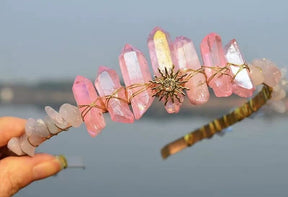 Pink crystal point tiara with a gold-tone sunburst motif and warm wire wrapping around the pale pink points.