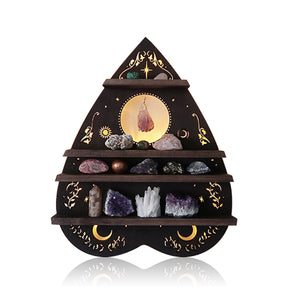 Dark planchette-shaped wooden shelf displayed against white, with golden celestial and vine details behind four tiers of decorative stones.