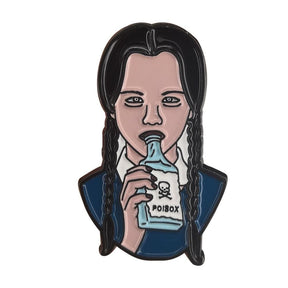 Gothic portrait enamel pin showing a figure with long black braids and a navy outfit lifting a pale blue bottle. The bottle label has a skull and the word Poison.