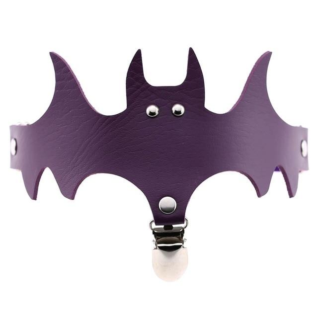 Purple bat-shaped garter with pointed wing tips, a matching band and silver-tone hardware.