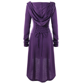 Back view of the purple dress with the hood lowered, showing its drape across the shoulders and rear waist lacing.