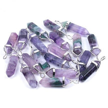 Purple fluorite pendants with faceted sides and pointed tips, arranged together with their silver-tone settings.