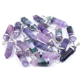 Purple fluorite pendants with faceted sides and pointed tips, arranged together with their silver-tone settings.