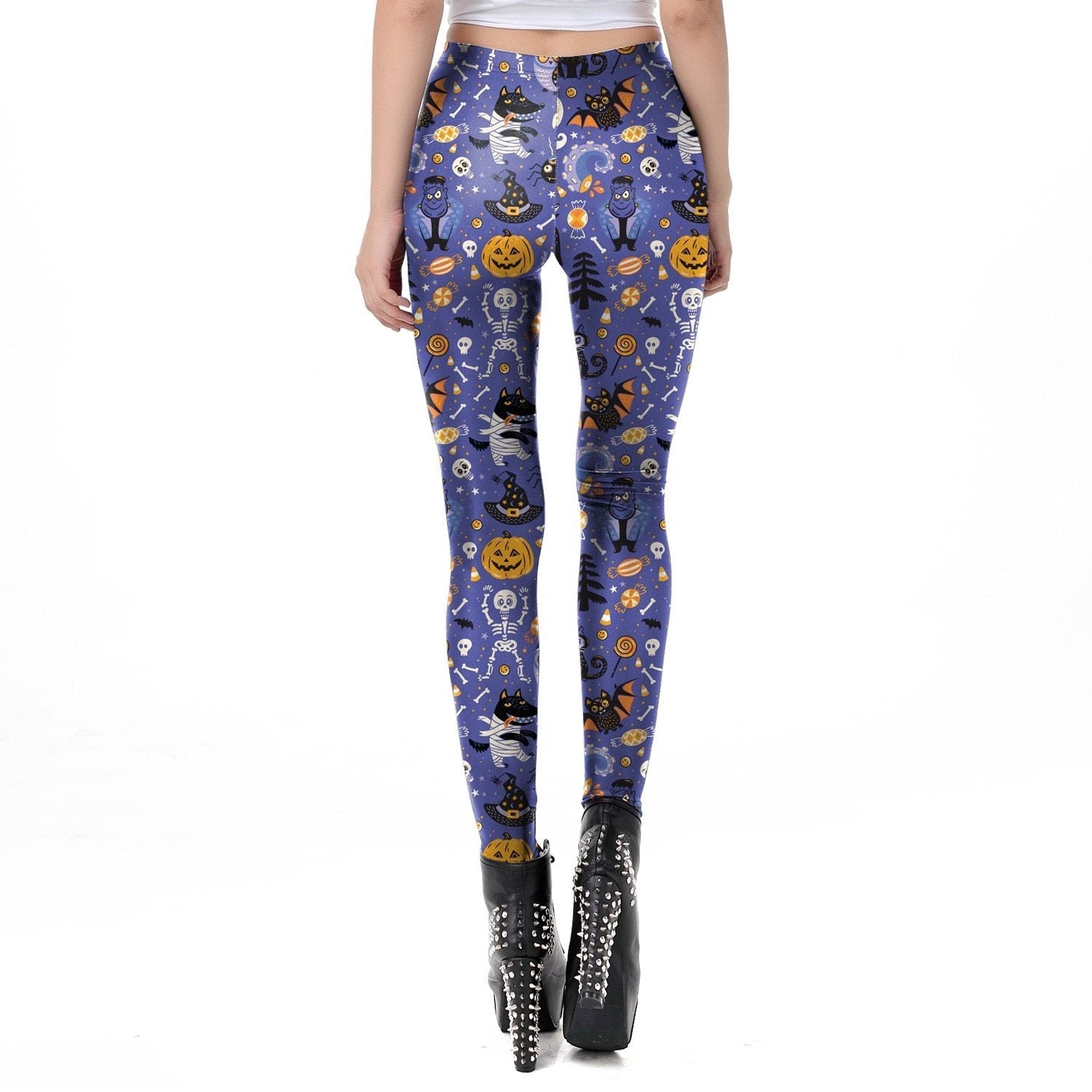 Rear view of the purple Halloween leggings with an all-over pumpkin, ghost and skull collage, styled with black lace-up platform boots.