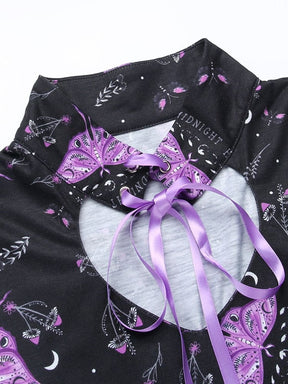 Dress collar laid flat with purple ribbon threaded through eyelets. Moth wings, crescent moons and fine botanical motifs surround the neckline.
