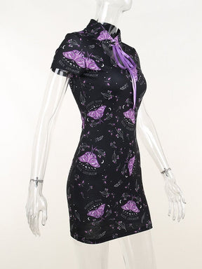Side view of the black moth-print mini dress on a clear mannequin, showing the close waist, short sleeve and curved chest opening.