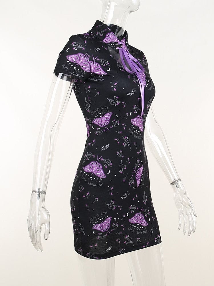 Side view of the black moth-print mini dress on a clear mannequin, showing the close waist, short sleeve and curved chest opening.