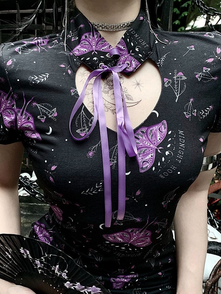 Close-up of the moth dress collar, showing purple ribbon laced through metal eyelets above the rounded chest cutout.
