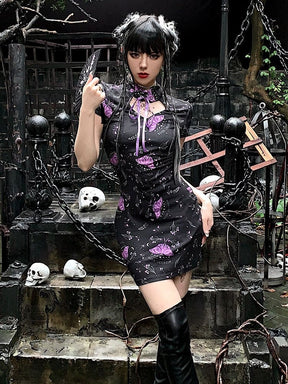 Full outfit view of the black purple-moth dress and tall boots on outdoor stone steps, with chains and skull decorations in the background.