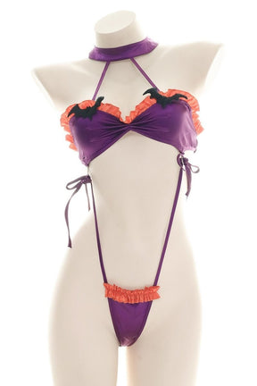 Purple and orange ruffled bat monokini with black bat embellishments, a matching neckband, and narrow side ties