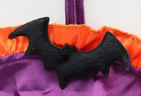 Purple and orange ruffled bat monokini with black bat embellishments, a matching neckband, and narrow side ties
