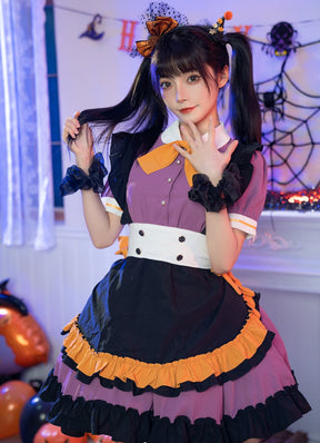 Front view of the Pumpkin Queen dress with short puff sleeves, a white buttoned waistband and orange-edged black apron panel, styled in a Halloween room.