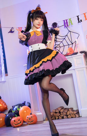 Full-length view of the purple Halloween dress with the skirt held outward, revealing the layered purple and black ruffles above black hosiery.