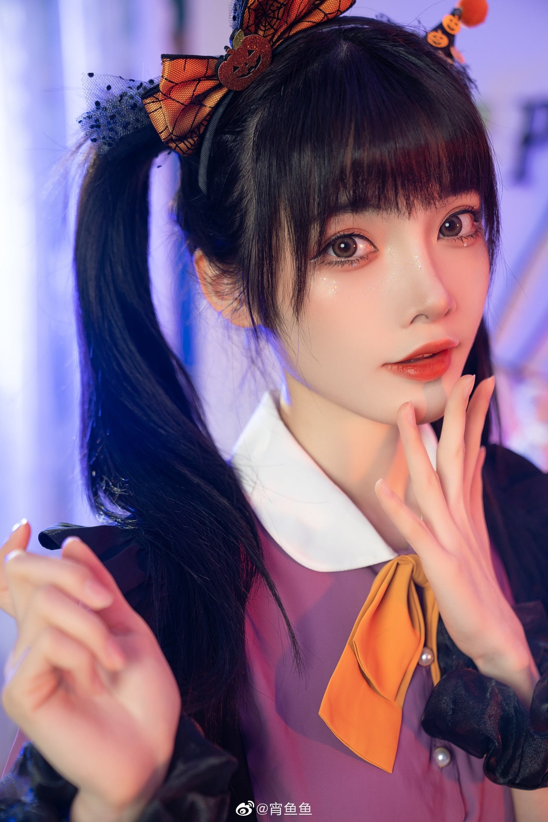Close portrait of the purple Halloween dress neckline, highlighting the rounded white collar, orange bow and gathered sleeve with a white band.