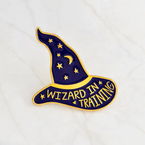 Purple Wizard in Training hat pin with a gold-tone crescent moon, stars and outlined brim.