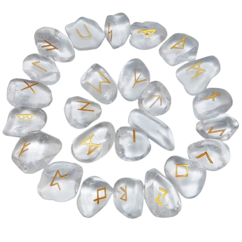 Quartz rune stones arranged in a circle, with clear and milky white polished surfaces and gold-coloured characters. The set includes a blank stone.