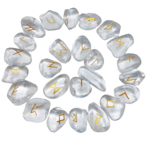 Quartz rune stones arranged in a circle, with clear and milky white polished surfaces and gold-coloured characters. The set includes a blank stone.