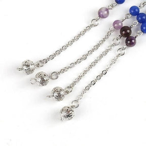 Several rainbow bead bracelet sections arranged together, showing small round beads and silver-tone openwork balls.