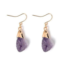 Pair of rough purple amethyst drop earrings with gold-tone caps and curved hooks.