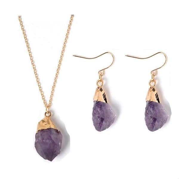 Raw purple amethyst pendant necklace and hook earrings with gold-tone caps on white.