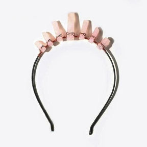 Pale pink quartz tiara with a taller central point and shorter points on either side, wrapped onto a dark headband.