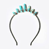 Turquoise-blue point tiara shown on its own, with pale and brown markings in the points and copper wire at their bases.