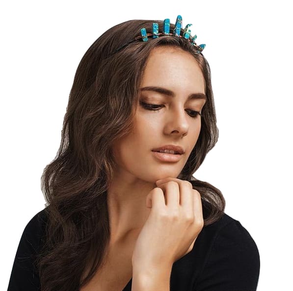 Woman wearing a turquoise-blue crystal point tiara over loose brown hair, with copper wrapping visible along the dark headband.